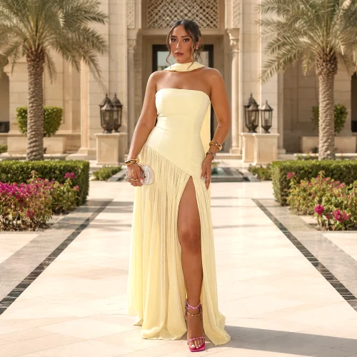 Alt: " Home product image – Acuvick " Elegant strapless mesh evening maxi dress for women with backless split design and pleated detailing in butter yellow.