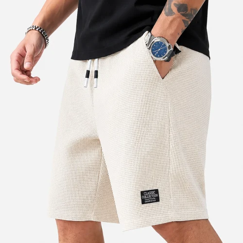 Men's textured casual beach shorts in beige colour with a lightweight summer fit, breathable fabric, and comfortable design for beach holidays, travel, and everyday casual wear.