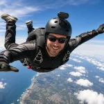 Full-body skydiver wearing a helmet-mounted Premium 4K Mini WiFi Action Camera while recording a freefall adventure in 4K Ultra HD.