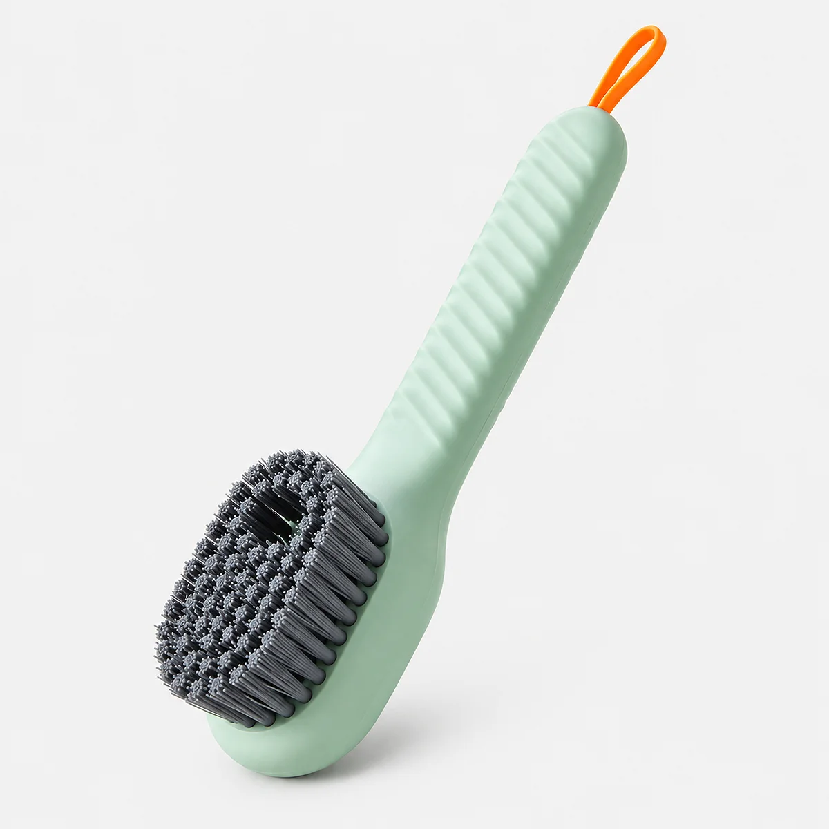 Alt: " Automatic Soap Dispensing Shoe Cleaning Brush with Soft Bristles product image – Acuvick " Light green Acuvick automatic soap dispensing shoe cleaning brush featuring dense grey soft bristles, a grooved ergonomic handle, and an orange hanging loop.