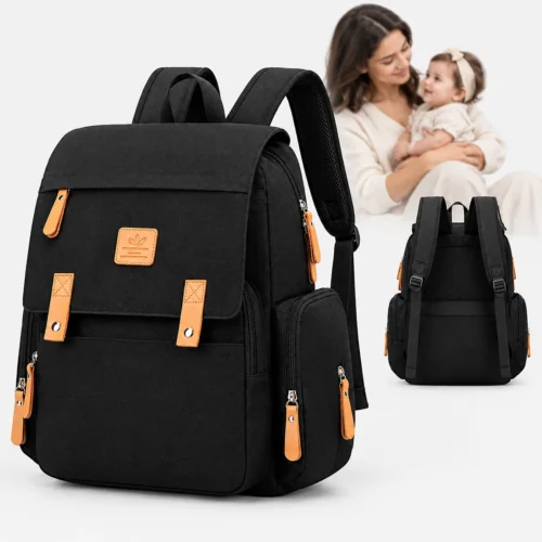 Multi functional black mommy diaper bag backpack with brown leather trim shown next to a mother cradling her baby